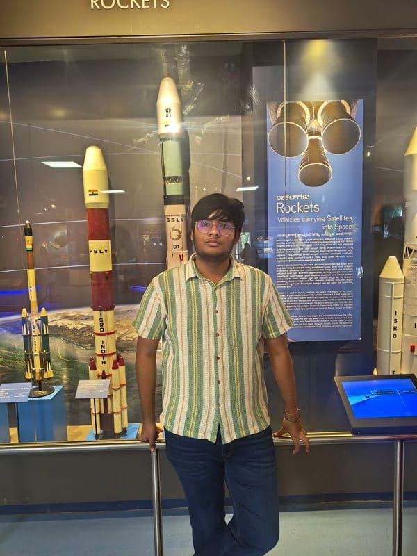 Anshveer in front of ISRO rocket models